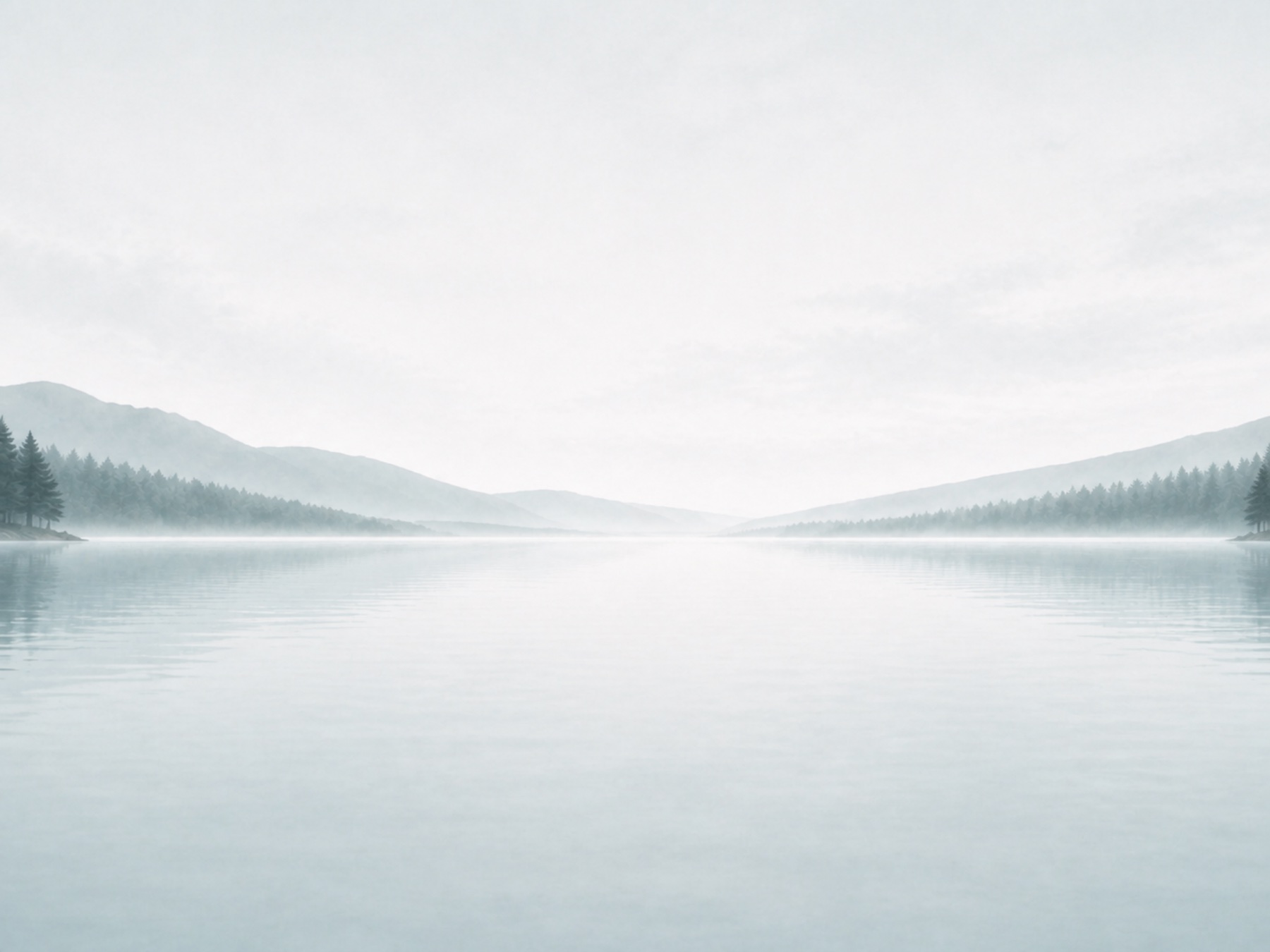 A pale misty mountain lake beneath an open sky