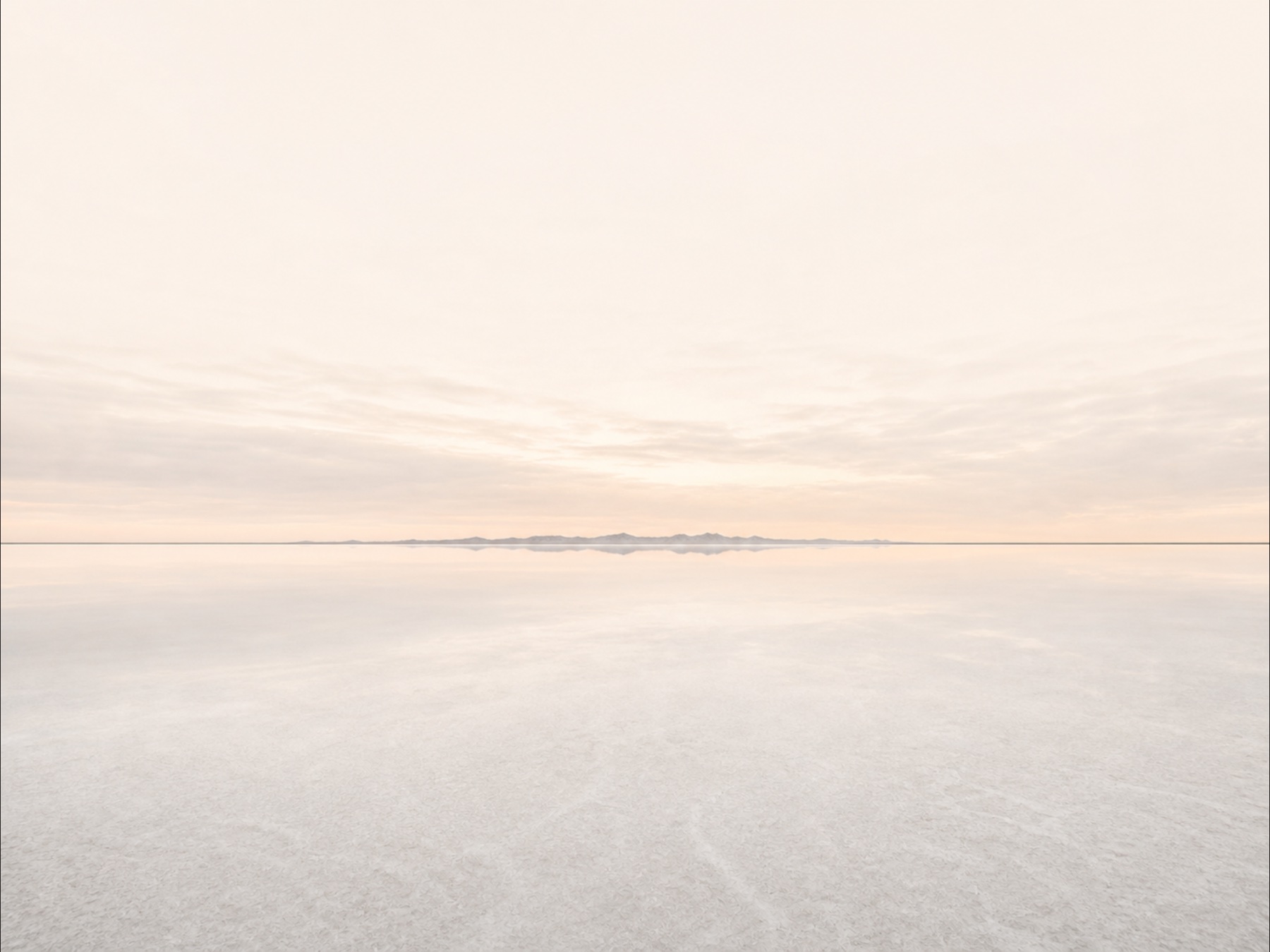 A pale salt horizon extending beneath a softly glowing sky